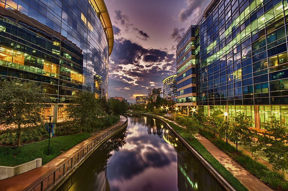 The Woodlands Waterway at dusk, reflecting a purple sky
